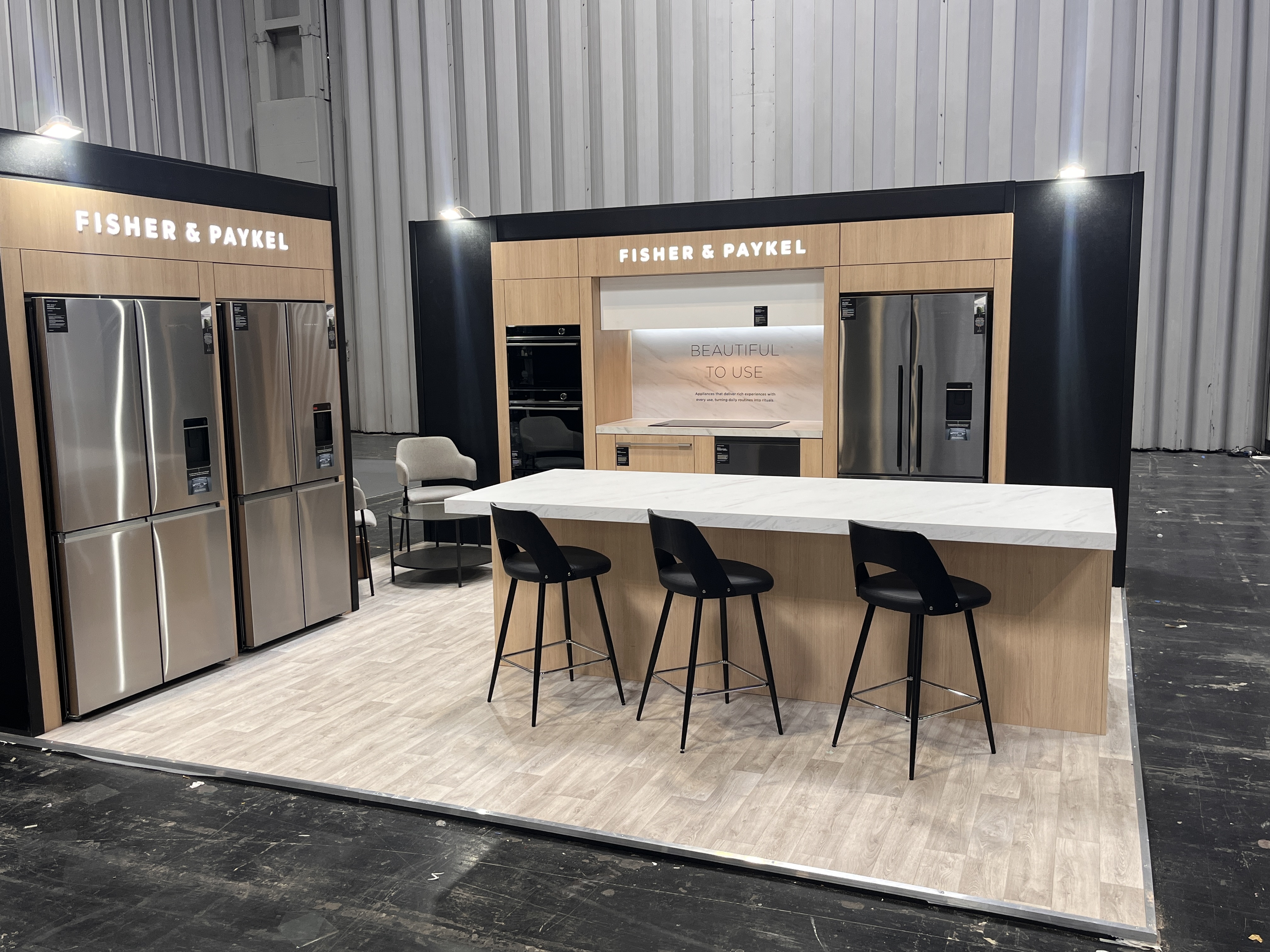 Fisher & Paykel premium appliance stand with oak and marble island at CIH 2025